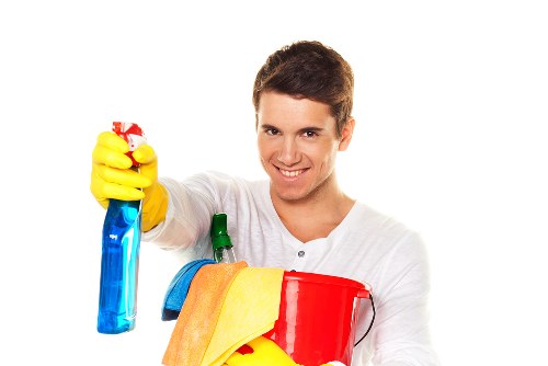 Domestic cleaner vacuuming a living room in Surrey
